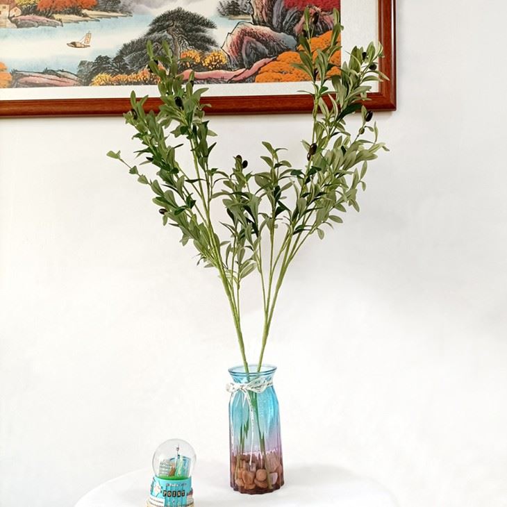 Faux olive branch in vase